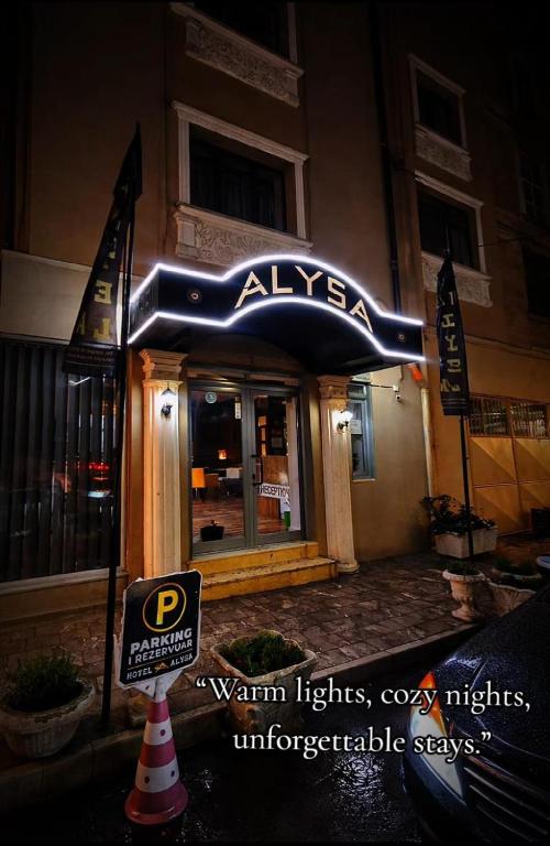 a restaurant with a sign on the front of a building at Hotel Alysa Korce in Korçë