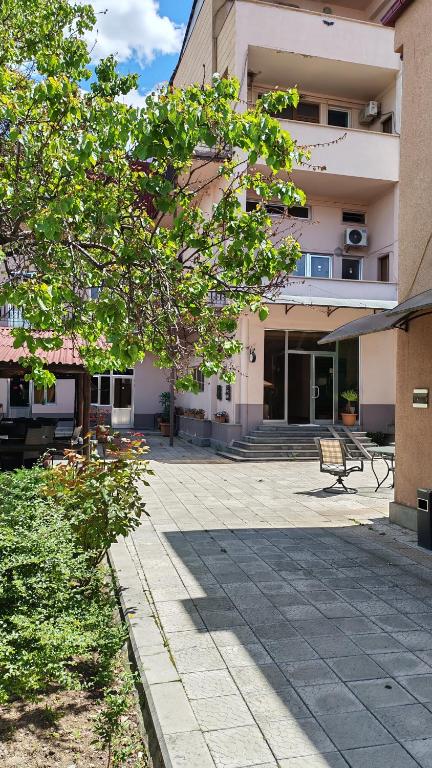 a building with a bench in front of it at Areg Hotel in Yerevan