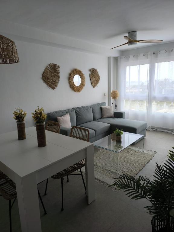 a living room with a couch and a table at Veneziola Golf II by Alina365 in La Manga del Mar Menor
