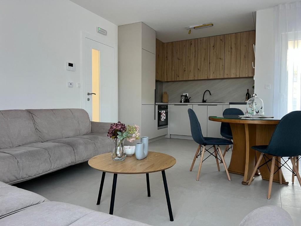 a living room with a couch and a table and a kitchen at Ana in Posušje