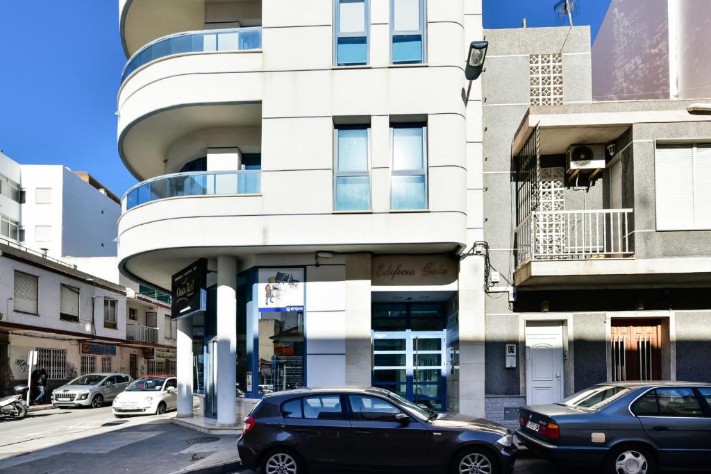 a black car parked in front of a building at Gala Centro Modern I in Torrevieja