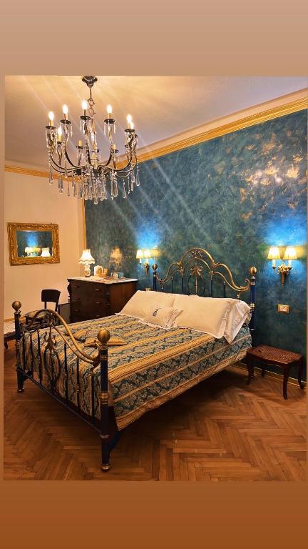 a bedroom with a bed with a chandelier at B&B Dai Toscans in Cividale del Friuli