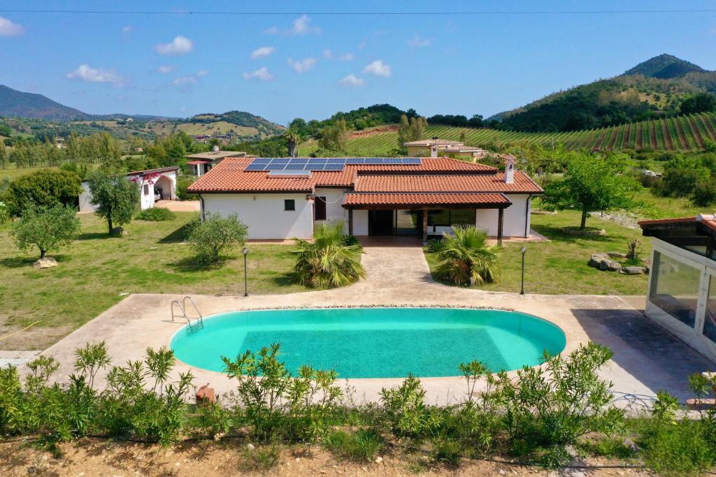 an image of a villa with a swimming pool and a house at Villa IS CARCURIS Jennas in Cardedu