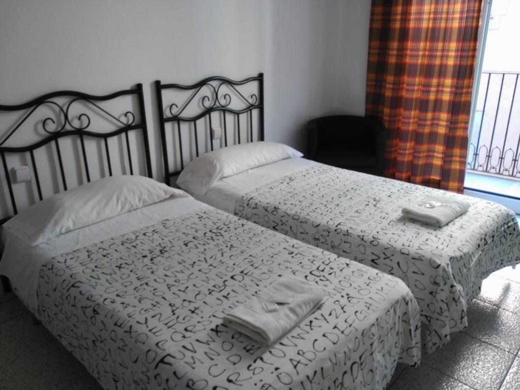Postel nebo postele na pokoji v ubytování Hostal River