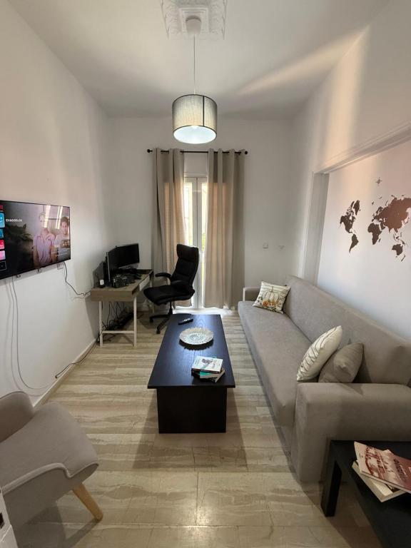 a living room with a couch and a table at METHONI LUXURY House in Methoni