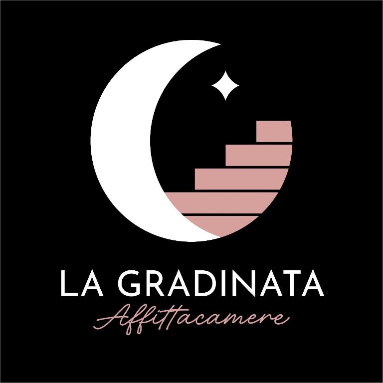 a white and pink symbol with a white at La Gradinata in Gonnosfanàdiga
