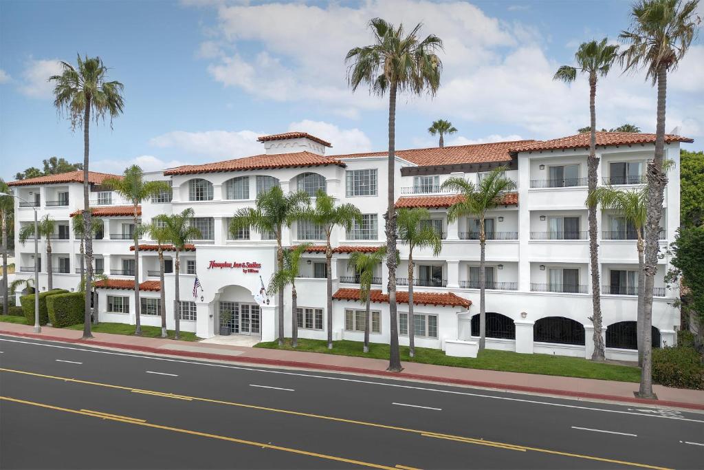 a white building with palm trees in front of a street at Hampton Inn & Suites San Clemente - Fully Renovated in San Clemente