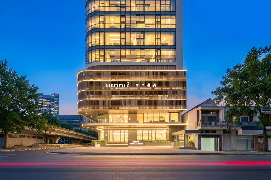 a tall building with a sign on the front of it at Ji Hotel Phnom Penh Downtown in Phnom Penh