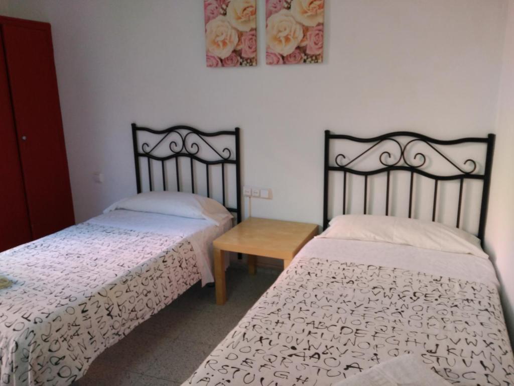 Postel nebo postele na pokoji v ubytování Hostal River