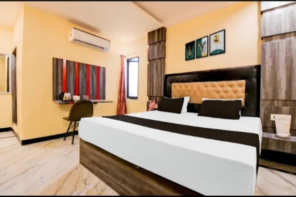 a bedroom with a large bed in a room at Amba palace in Prayagraj