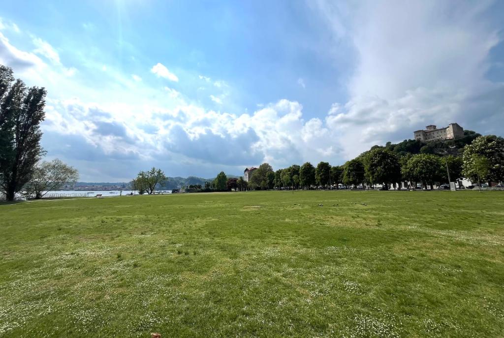 a large grass field with a house in the background at Lake and Rocca Suite in Angera