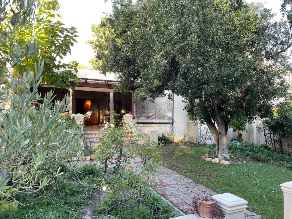 a house with a tree in the yard at Classic Home in Franschhoek in Franschhoek