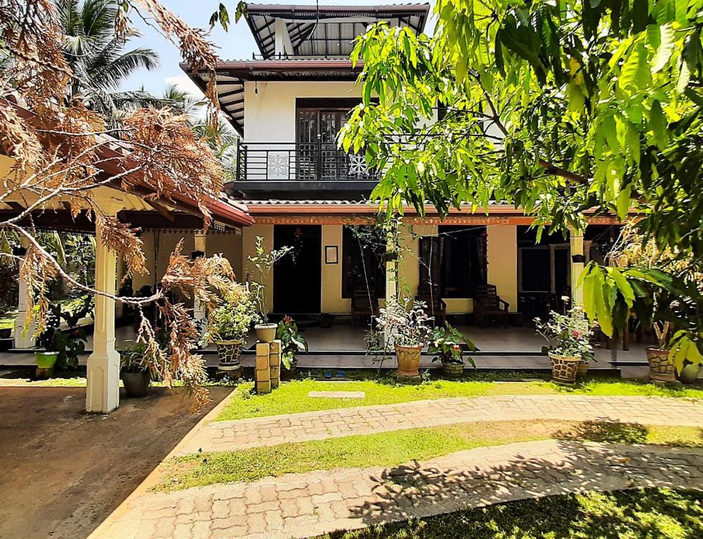 a house with a courtyard in front of it at The Green Heritance in Habarana