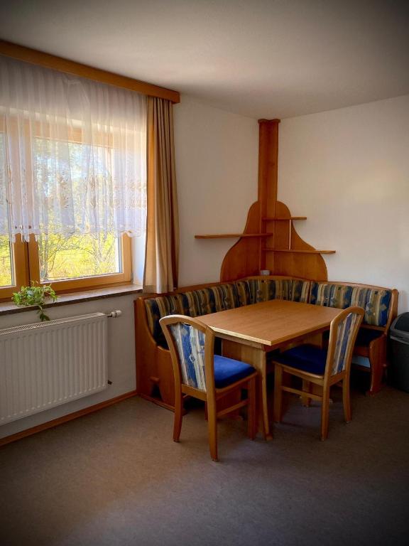 a living room with a table and a couch at Salzleckerhof in Lambach