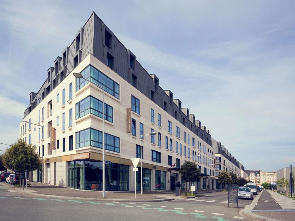 a large building on a street with a street at Mercure Saint Malo Balmoral in Saint Malo