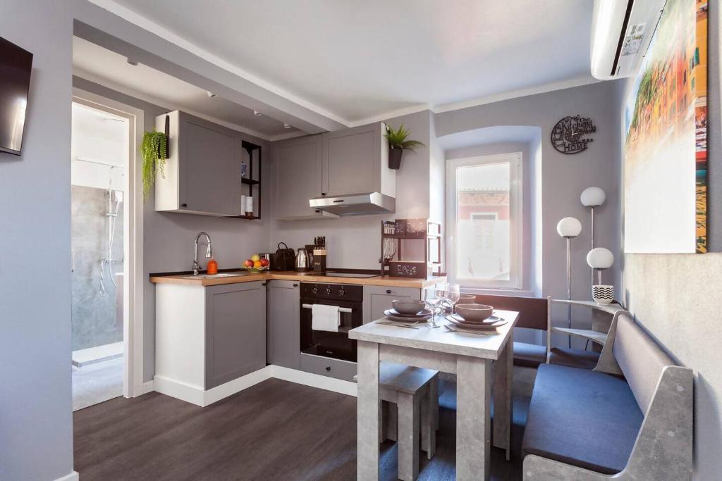 a kitchen with a small table and a table and a table at Il nido di Argegno in Argegno