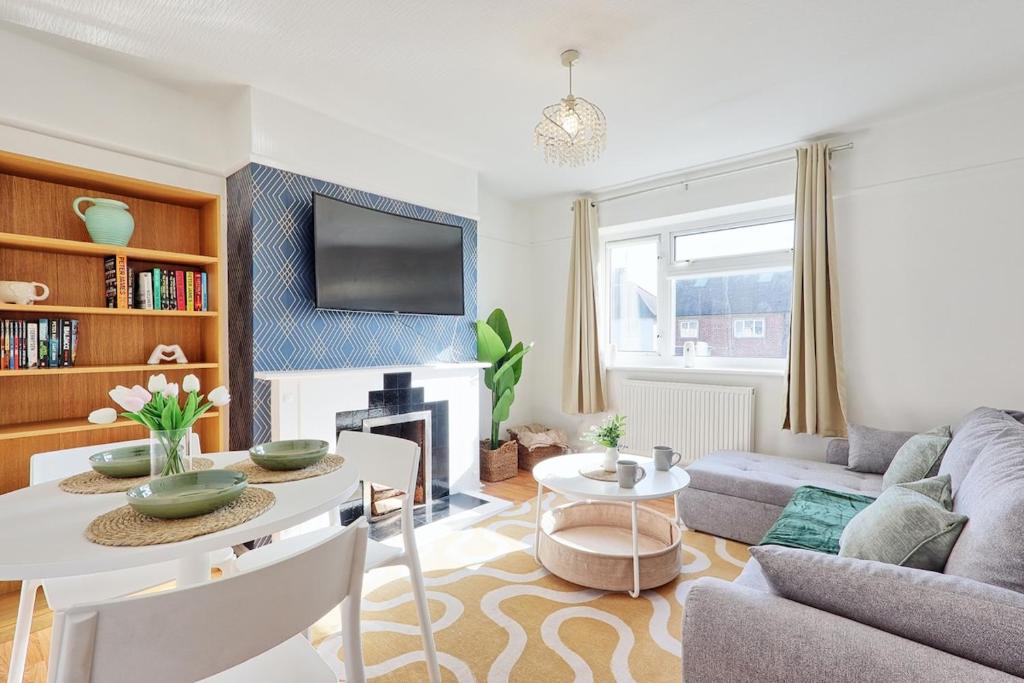 a living room with a couch and a table at 1 bed, office space, private parking, contractors in Chelmsford