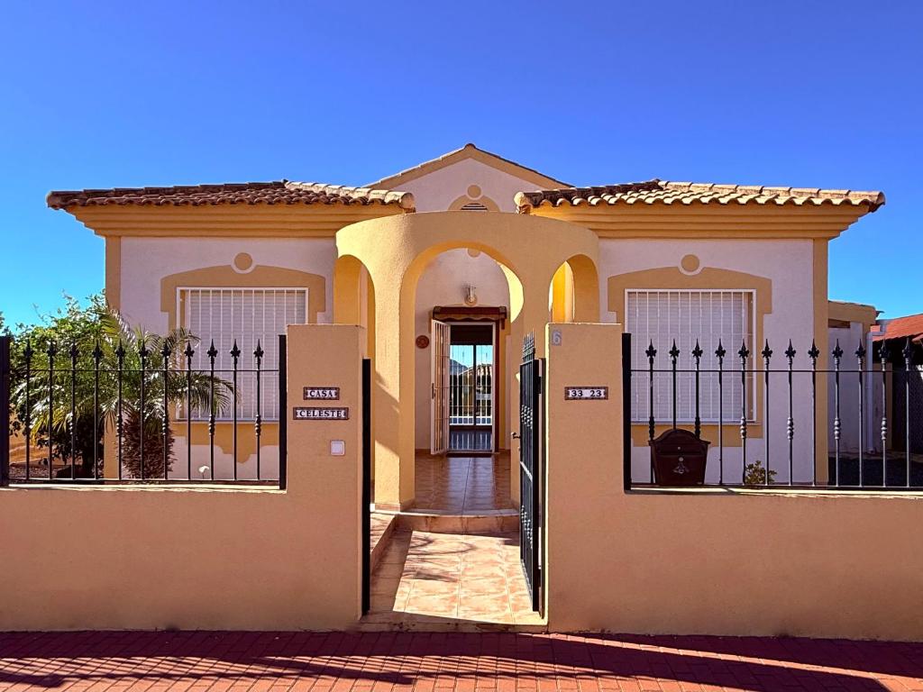 a house with a gate in front of it at Casa Celeste with private pool in Mazarrón
