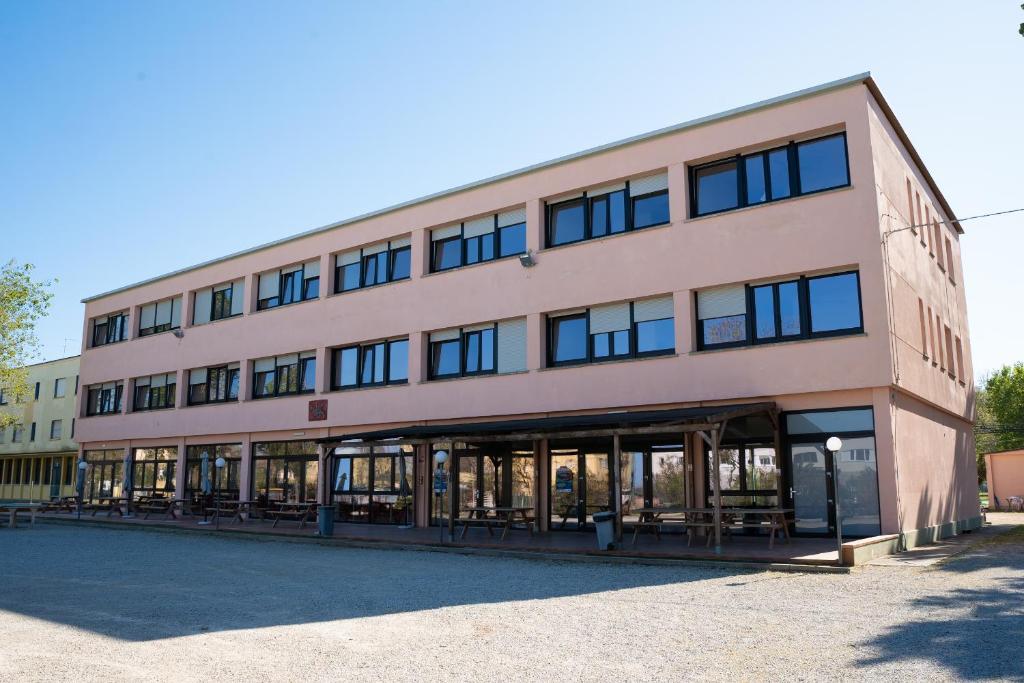 a large building with a lot of windows at Ostello Paradiso EuroCamp in Cesenatico