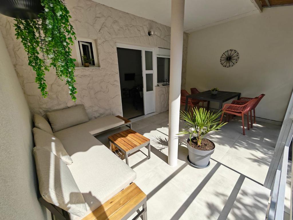 a living room with a couch and a table at Apartment Helena Rovanjska in Rovanjska