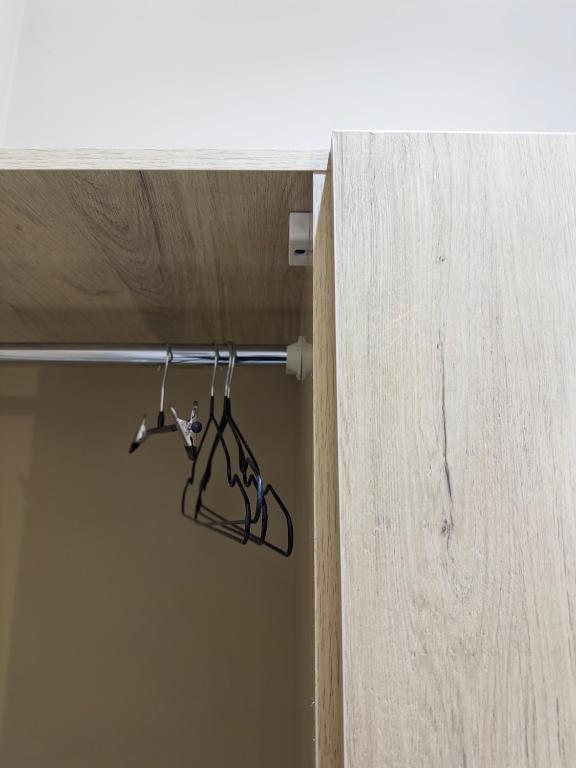 a pair of hangers hanging from a wooden door at شقق النهضه in Al Khobar