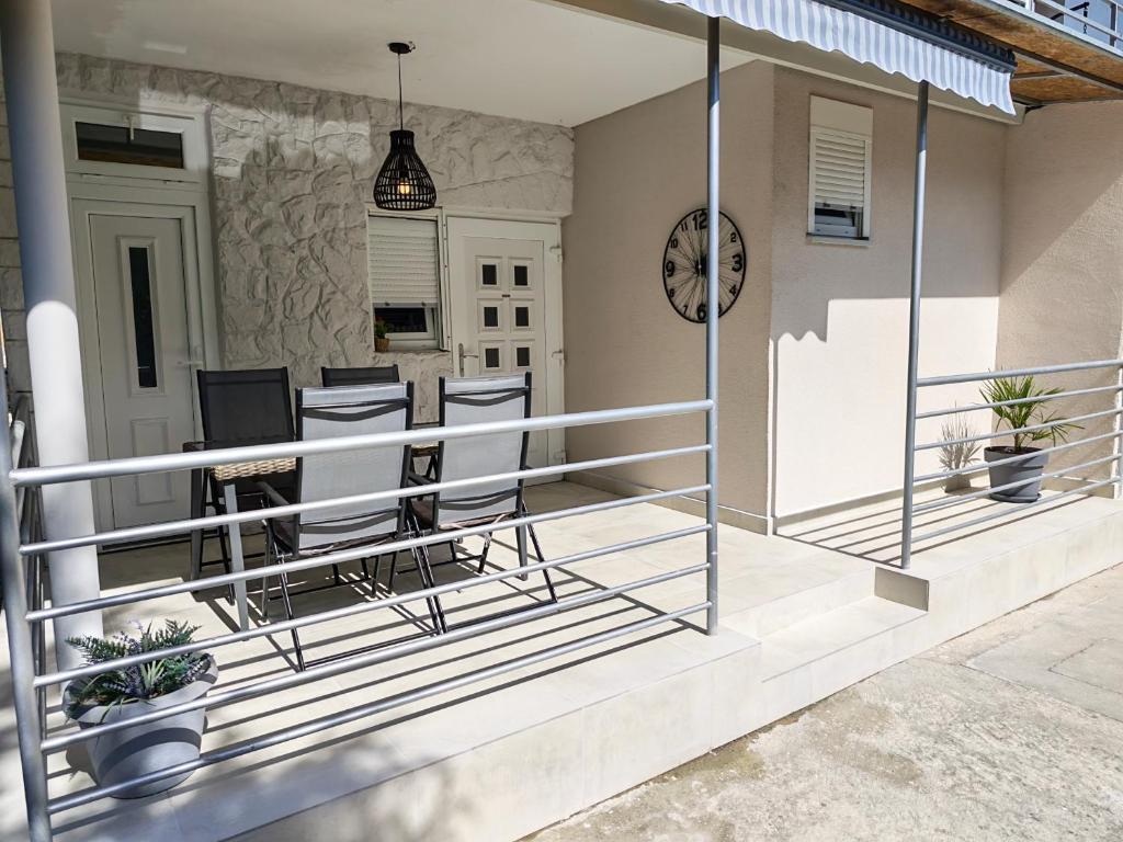a balcony with glass railings on a house at Apartment Sunset Rovanjska in Rovanjska