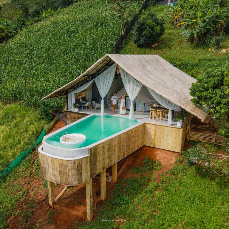 an overhead view of a house with a swimming pool at เดอะเฌอร์ โฮมสเตย์-The Sher in Ban Thung Phan Ha