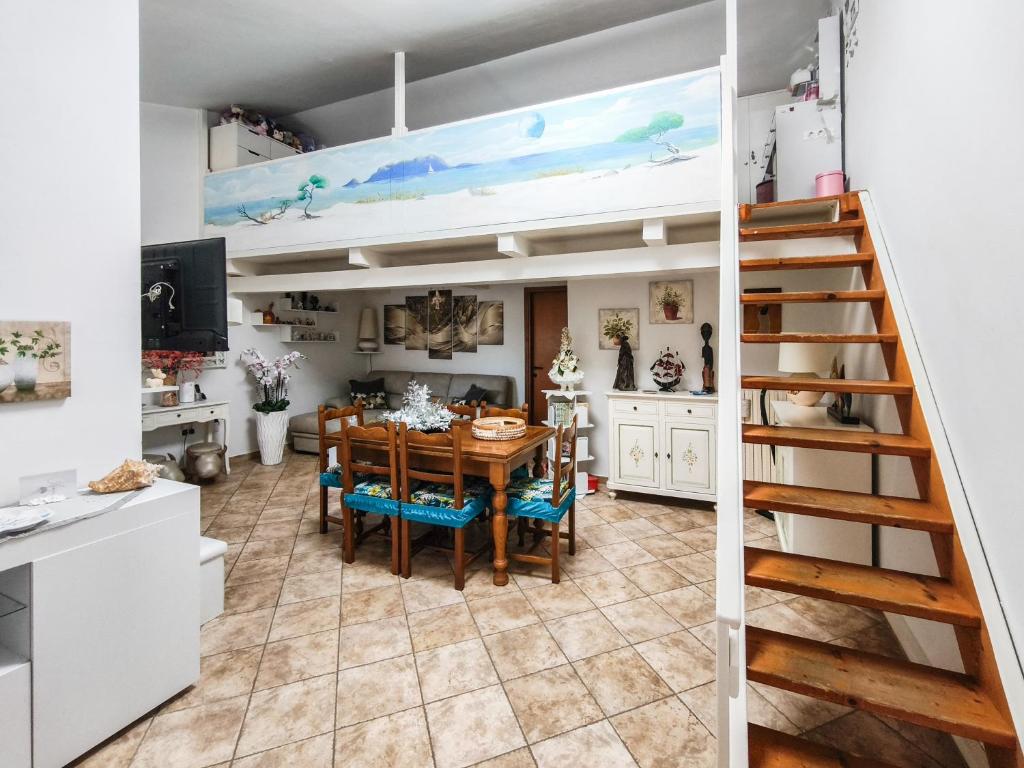 a kitchen and dining room with a table and chairs at Magic DaLu House in Olbia