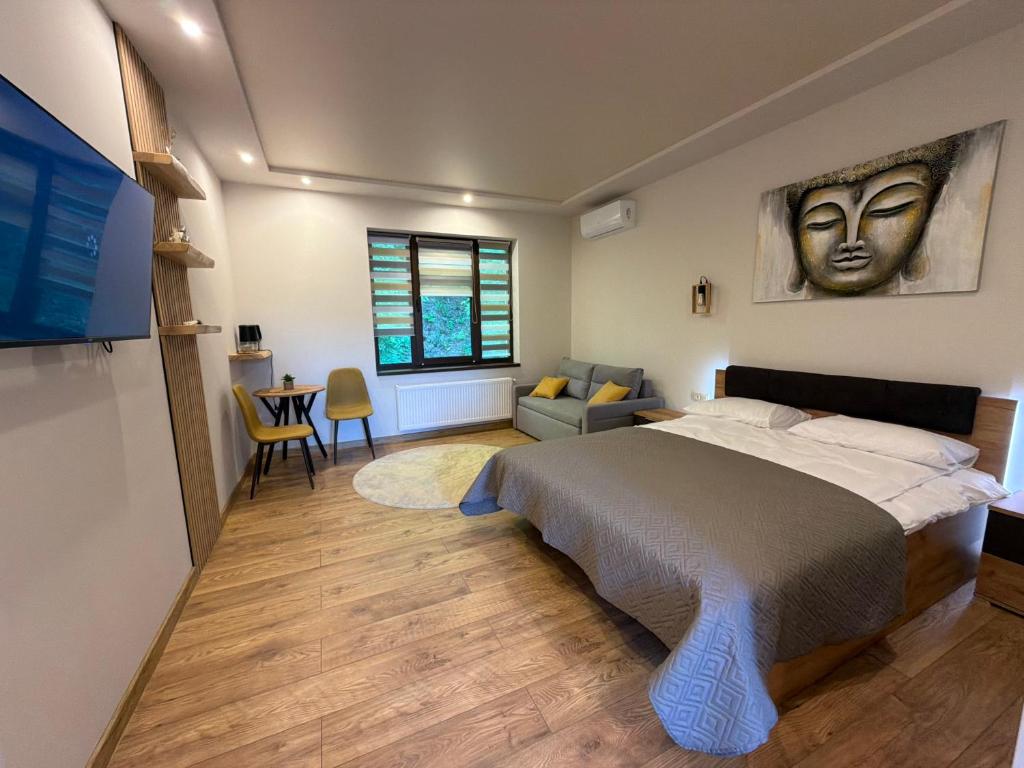 a bedroom with a large bed and a table at Апартаменти Фігля з видом на гори in Mukacheve