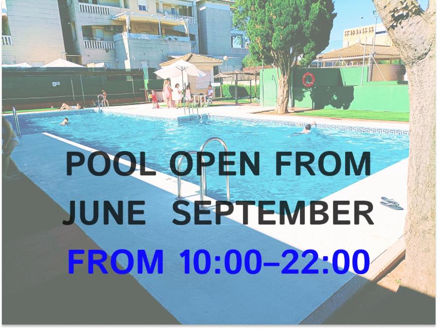 a swimming pool open from june september with a sign next to it at Casa Micho in Tomares