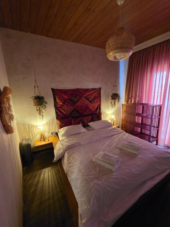 a bedroom with a large bed with a red headboard at Sherlock Home in Komotini