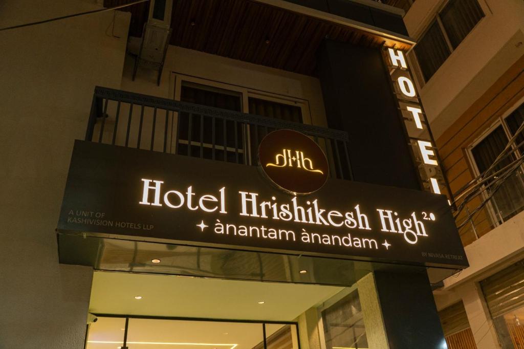 a sign for a hotel in a building at Hotel Hrishikesh High Tapovan in Rishīkesh