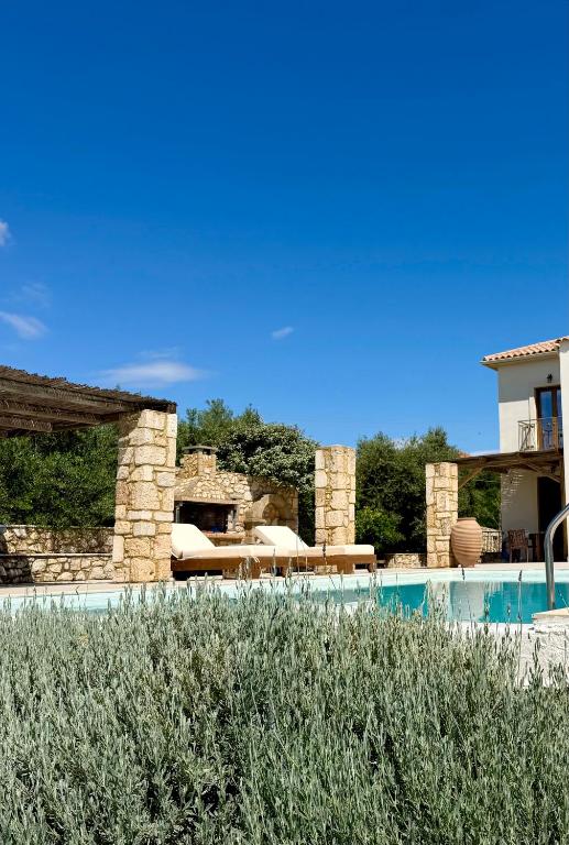 a house with a swimming pool and a building at Onirozo Koroni Private Villa in Koroni
