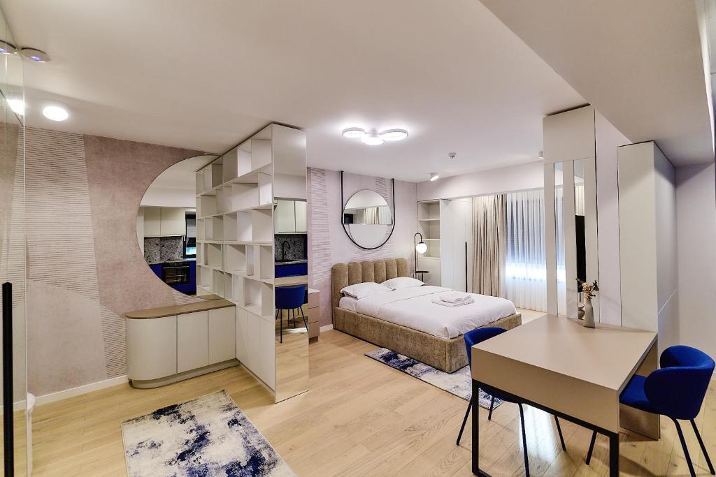 a bedroom with a bed and a desk and a table at Unique by UpTown Apartments in Iaşi