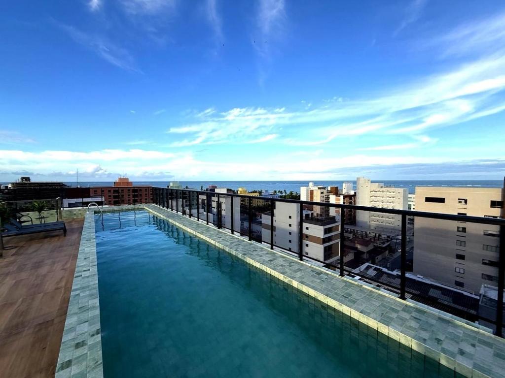 a swimming pool on the roof of a building at Emunah Flat Luxo Cabedelo • Piscina no Rooftop in Cabedelo