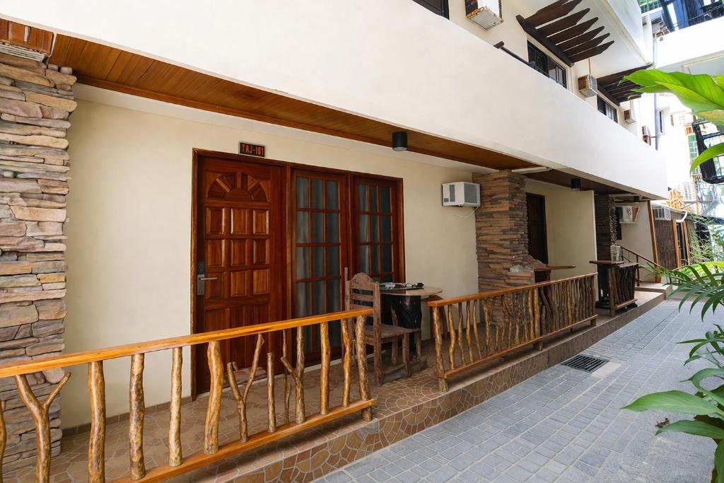 a balcony of a house with a wooden door at Taj Resort and Spa in Boracay