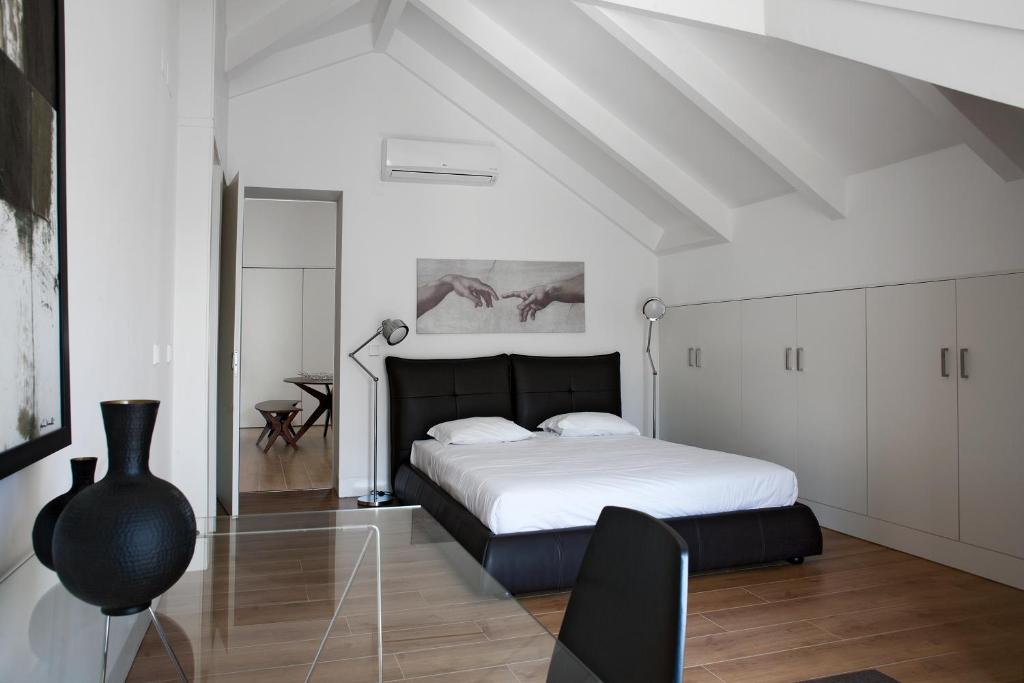 a white bedroom with a bed and a table at LSA Baixa Chiado by Numa in Lisbon