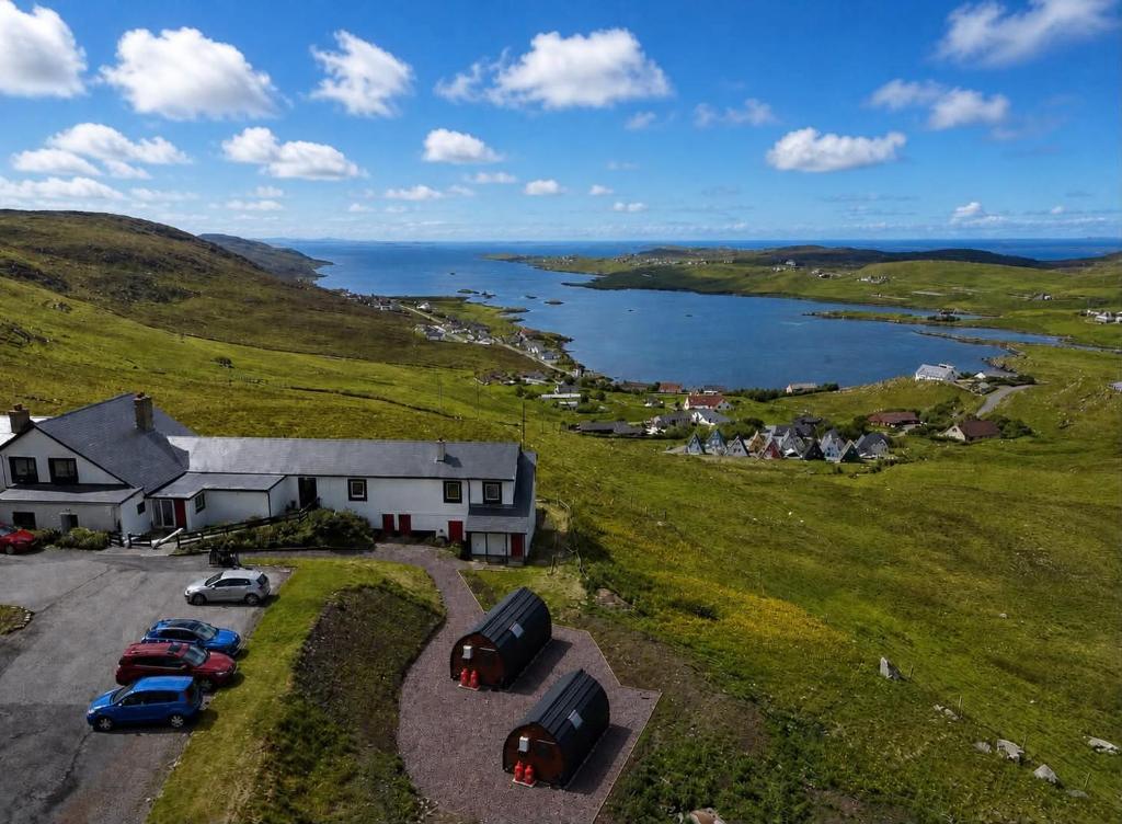 an aerial view of a house with cars parked in a field at The Westings in Tingwall