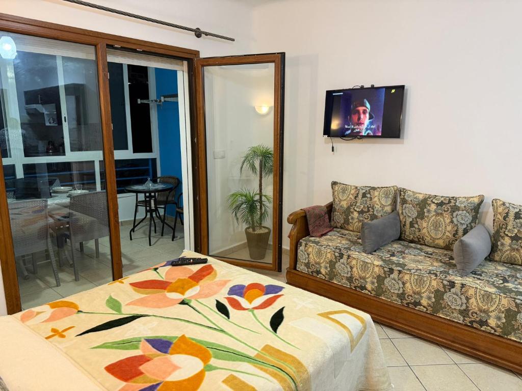 a living room with a couch and a tv at Cabo Dream 51 in Cabo Negro