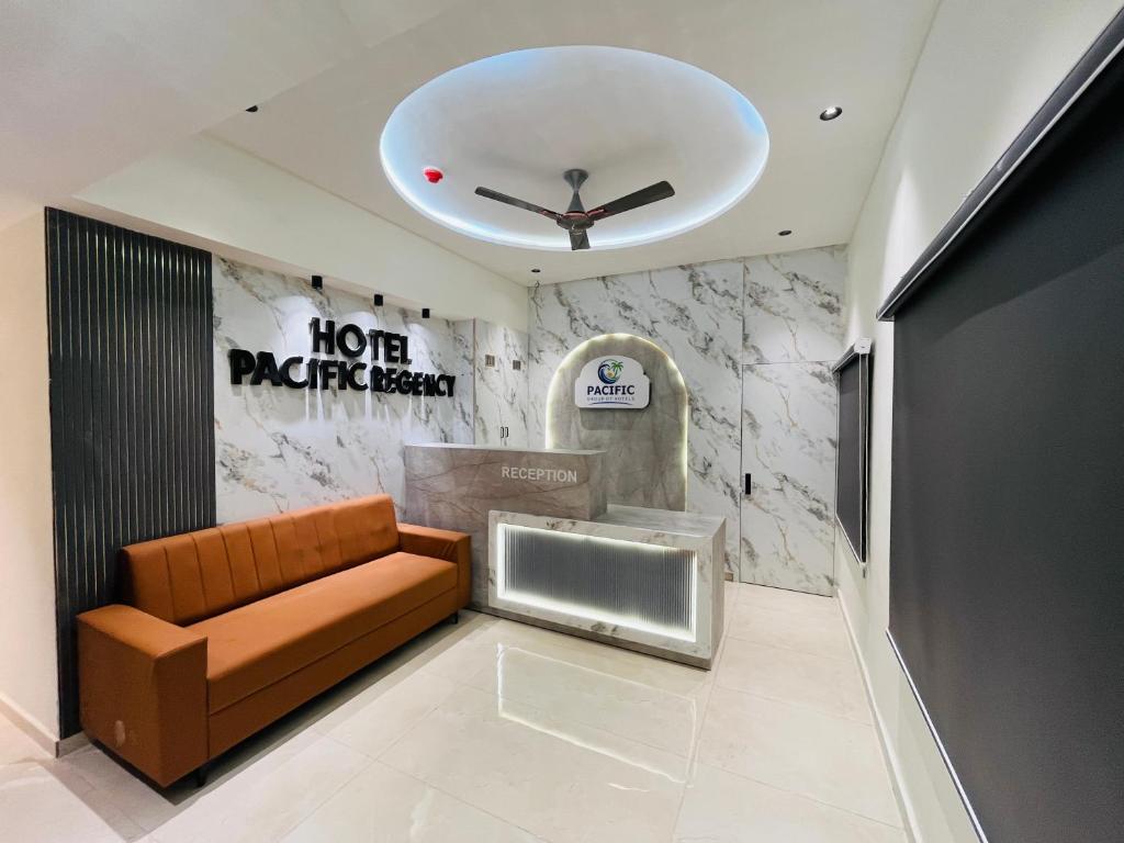 a living room with a couch and a clock on the ceiling at Hotel Pacific Regency in Ahmedabad