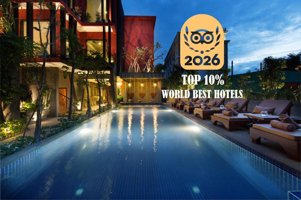 a hotel swimming pool with a sign that reads top world best hotels at Golden Temple Villa in Siem Reap