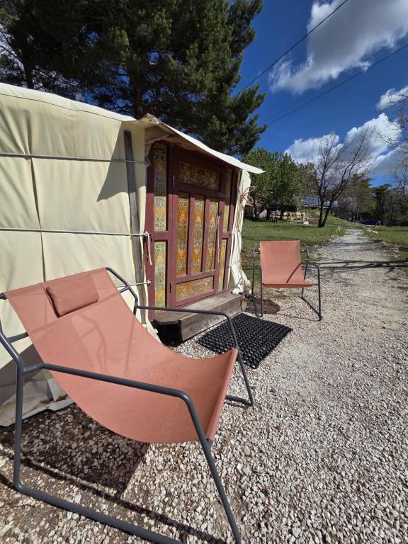 a couple of chairs sitting in front of a tent at Destination Ailleurs eco-domaine & spa in Castellane