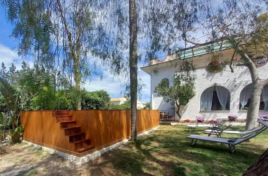a backyard with a wooden fence and a bench at Addaura Paradise House in Palermo