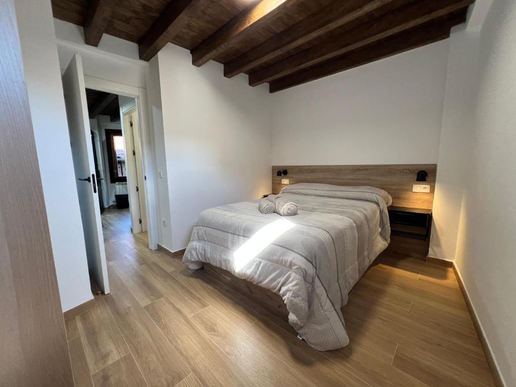 a bedroom with a large bed and a wooden floor at Raíces in La Alberca