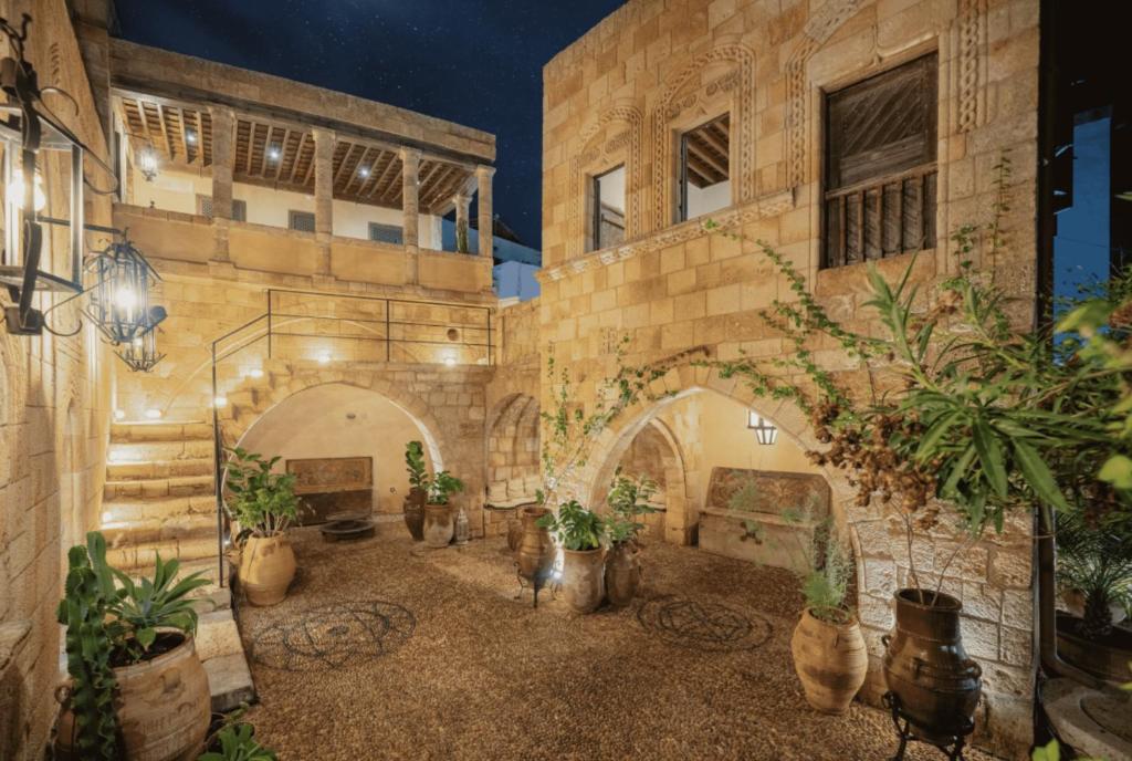 a building with a courtyard with potted plants in it at Vasilikos Mansion - Captains Residences in Lindos