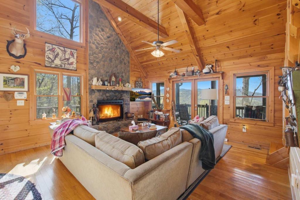 a living room with a couch and a fireplace at Not Your Average Bear Hot Tub in Blue Ridge