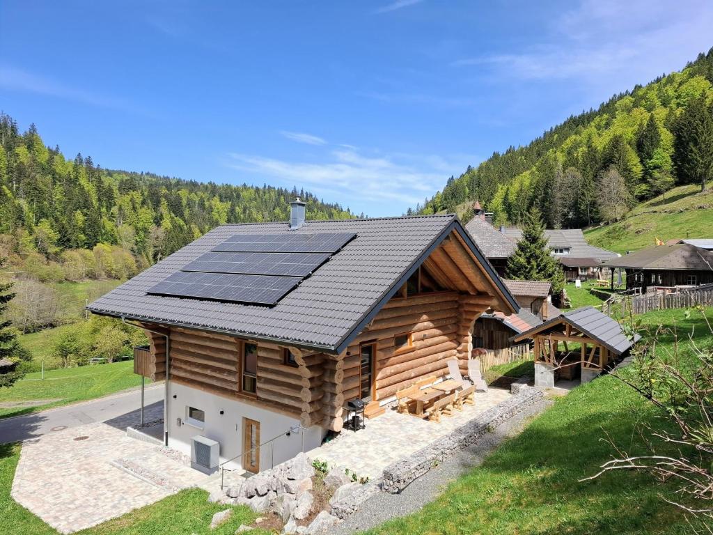 a house with solar panels on the roof at Ferienblockhaus "Glashütte" mit Sauna, Todtmoos in Todtmoos