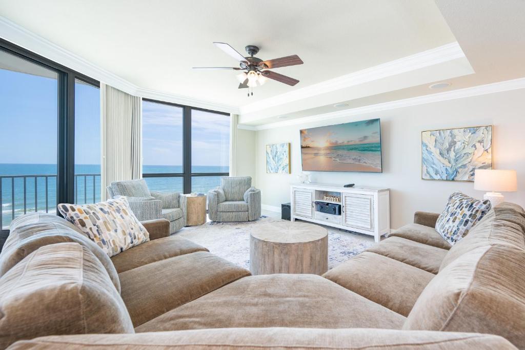 a large living room with a couch and a tv at Phoenix IX 707 in Orange Beach