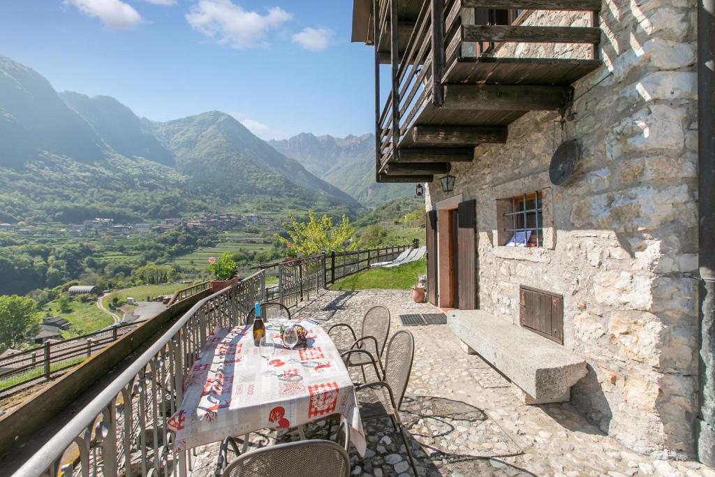 a table and chairs on a balcony of a building at Private Green Oasis - Terrace - Happy Rentals in Tenno