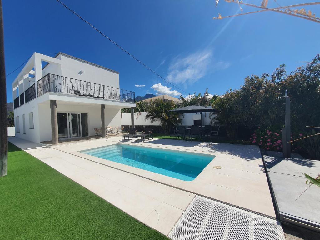 a house with a swimming pool in the yard at Casa Sandra in Tazacorte